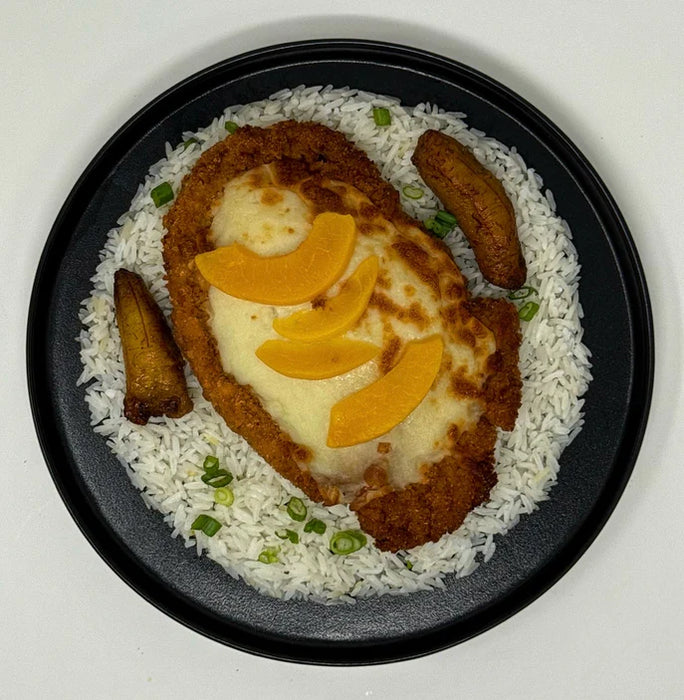 Breaded chicken with melted mozzarella cheese covered with peaches over a bed of yellow corn rice paired with maudros and veggie mix.