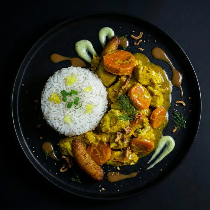 Plated dish of curry with vegetables and rice on a black background. The Halal Meal Preps