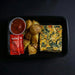 Meal in a black tray with frittata, potatoes, and Hunt's tomato ketchup on a dark background