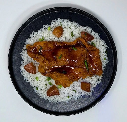 Honey garlic-crusted&nbsp;chicken paired with&nbsp;jasmine rice, green beans, and a side cup of pineapples.