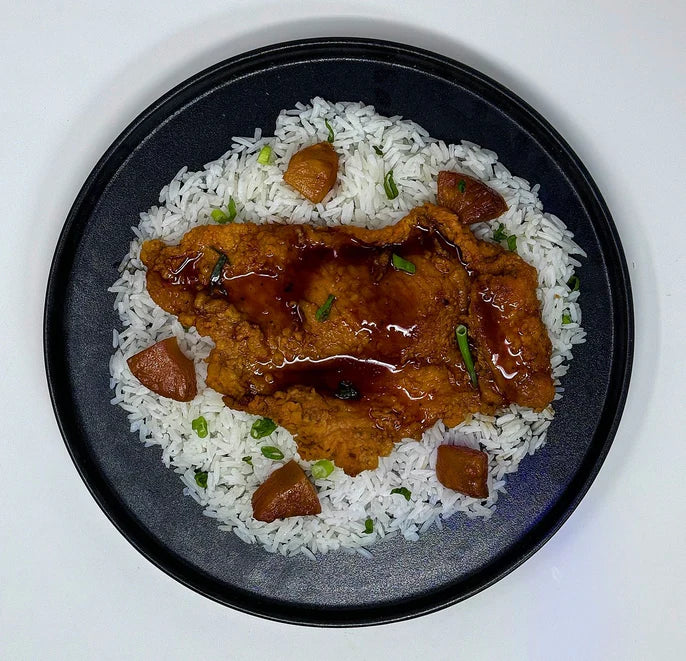 Honey garlic-crusted&nbsp;chicken paired with&nbsp;jasmine rice, green beans, and a side cup of pineapples.