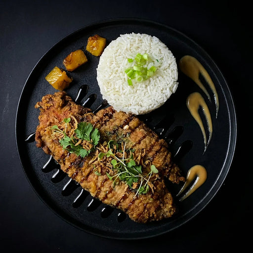 Fried chicken with rice and vegetables on a black plate. The Halal Meal Preps