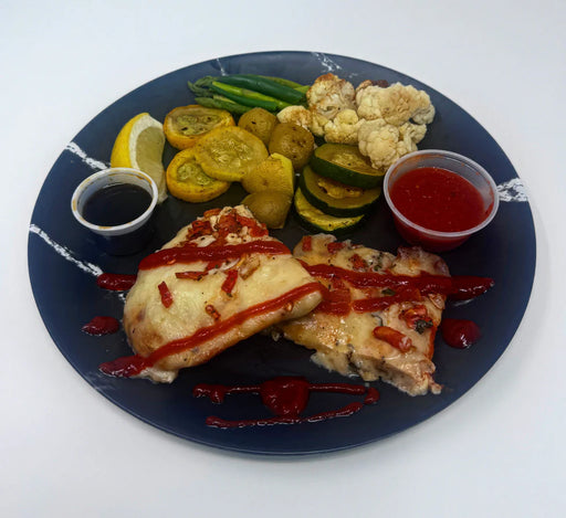 Plated dish with pizza, vegetables, and sauces on a blue plate. A Meal Made By The Halal Meal Preps.