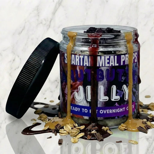 Two jars of Spartan Meal Prep Jilly on a marble surface with a black lid.