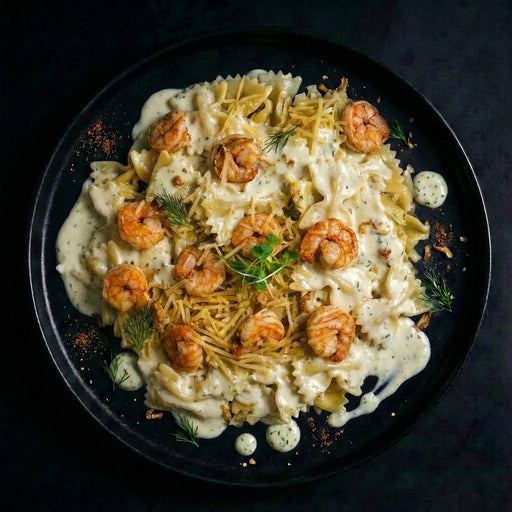 Plated dish of pasta with shrimp on a dark background