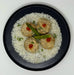 Dish with rice, meatballs, and asparagus on a white background
