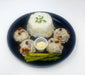 Dish with rice, meatballs, and asparagus on a white background
