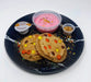 Stack of pancakes with colorful toppings on a black plate with side dishes including a pink yogurt and granola. A meal made by the halal meal prep.