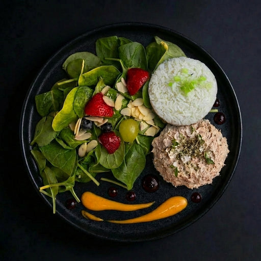 Plated food arranged to resemble a face with salad, rice, and meat patty on a dark background
